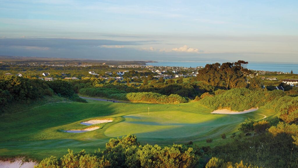 I need alt text for a photo showing part of a golf green and the st francis links clubhouse